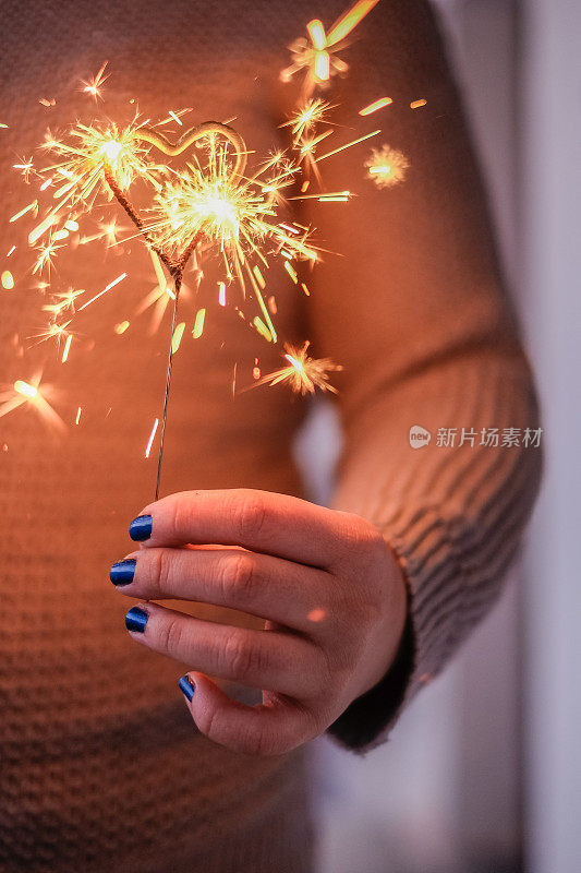 Woman's hand holding a sparkler